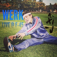 a woman is laying on the grass with the words work live o f 45